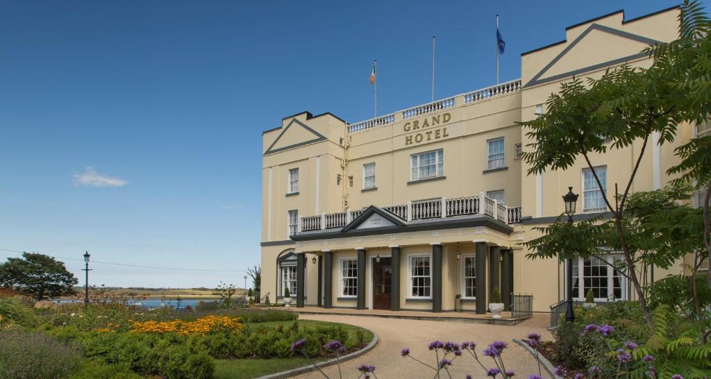 a large building with a garden in front of it at Grand Hotel in Malahide