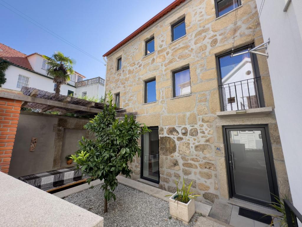 a stone house with a courtyard at Casa das Flores in Oliveira do Hospital
