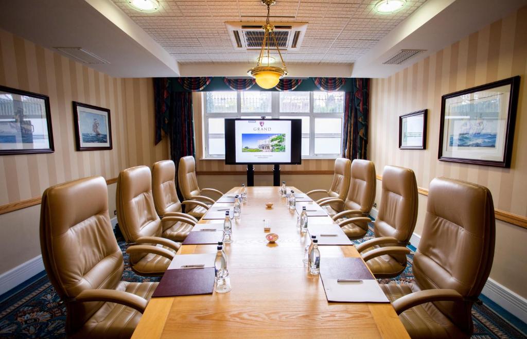 a conference room with a long table and chairs at Grand Hotel in Malahide