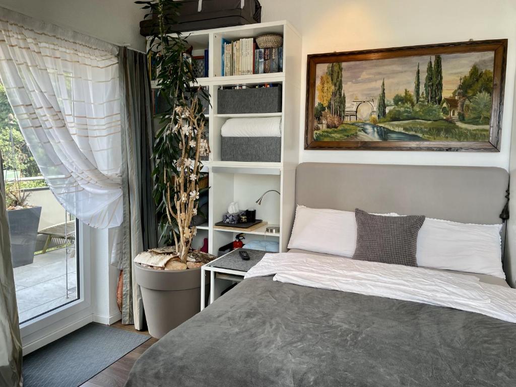 a bedroom with a bed and a book shelf at Guest Room in Stuttgart-Nord in Stuttgart