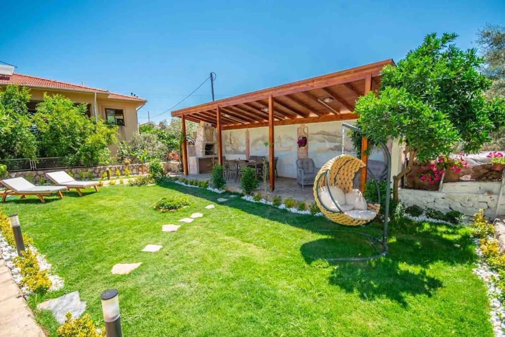 a backyard with a chair and a pavilion at VillaAnforaSelimiye in Selimiye