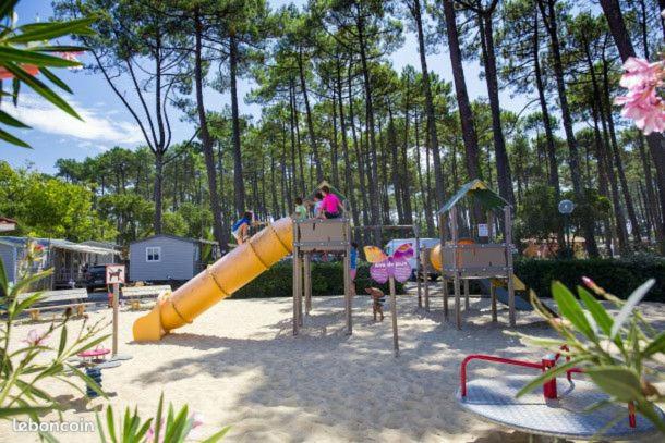 a playground with children playing on a slide at Mobil home 4&#47;6 personnes in Seignosse