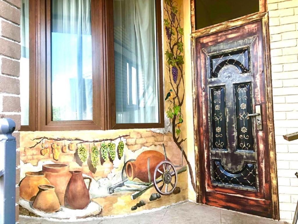 a painting of a house with a door and windows at Batumi Wonderland Guest House in Batumi
