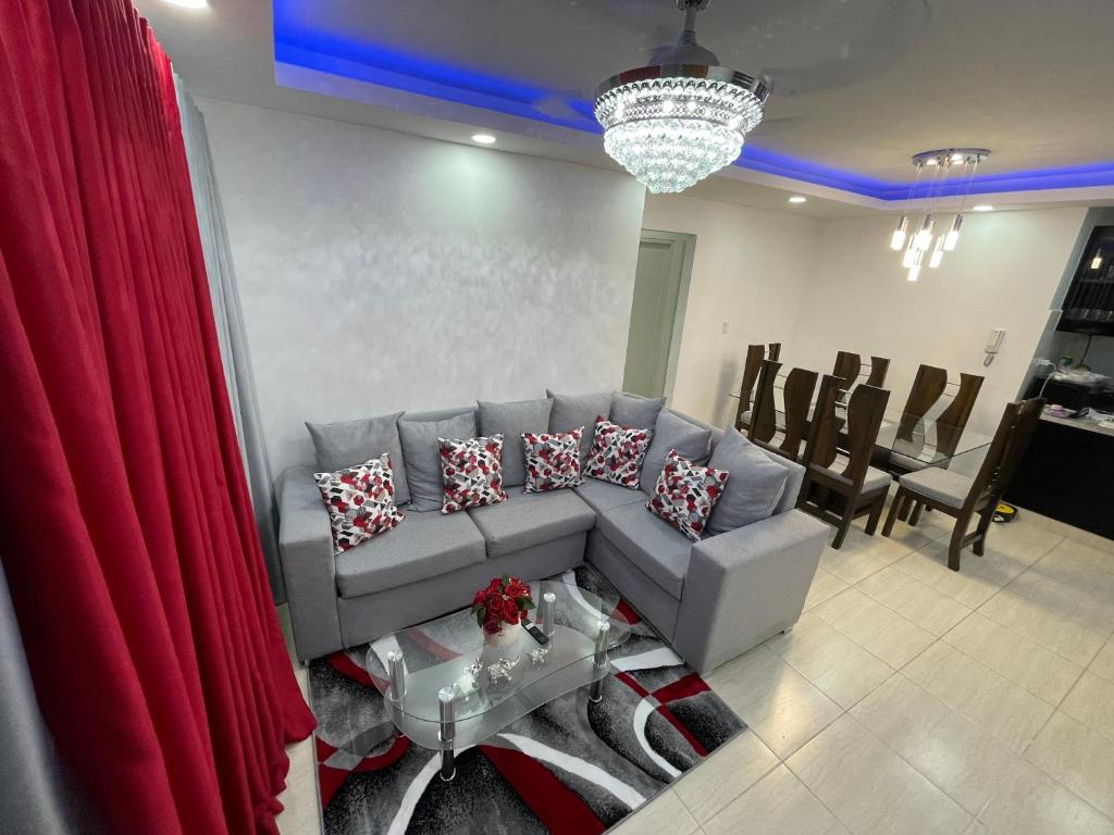 a living room with a couch and a red curtain at Joel Arturo Residences in Licey al Medio