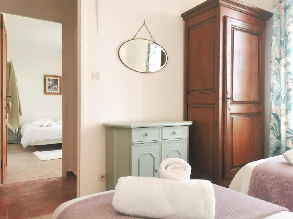 a room with a bed and a mirror on the wall at The Olive Press - Mon Lodge en Provence in Caromb