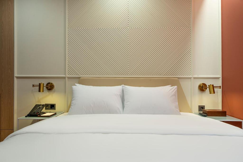 Postel nebo postele na pokoji v ubytování Busan H-AVENUE Hotel Seomyeon Station
