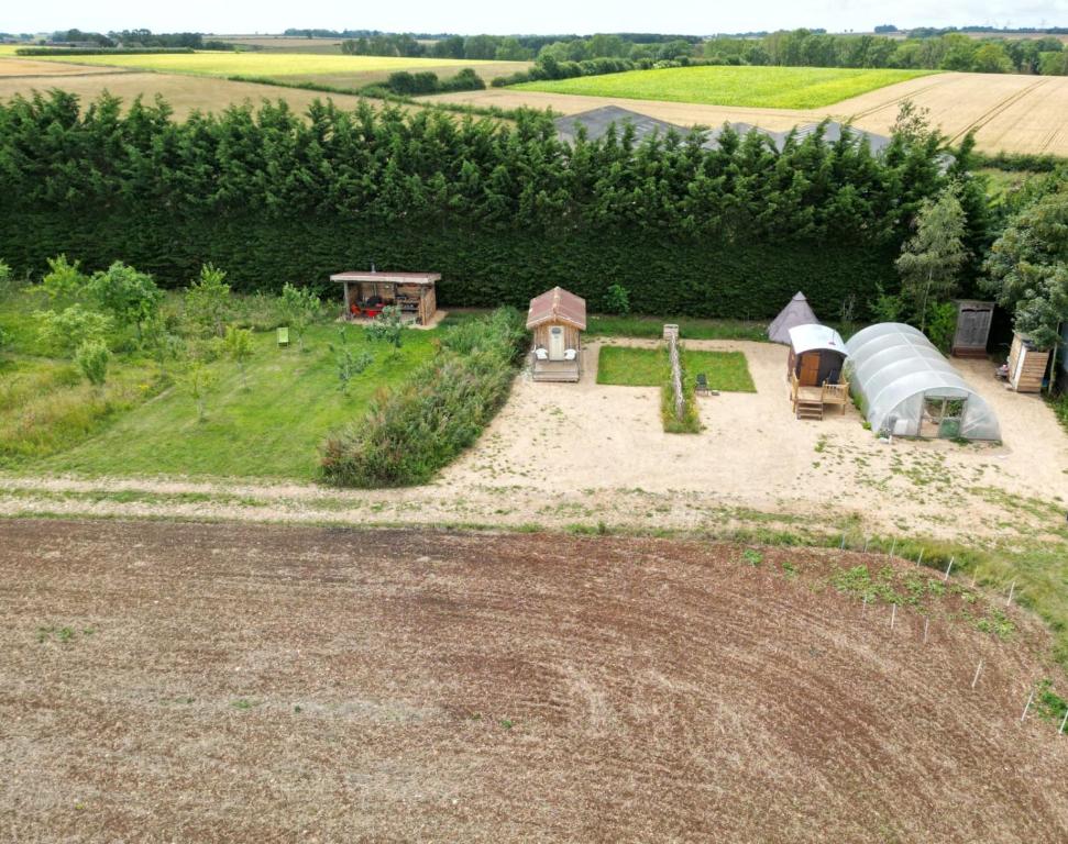 an aerial view of a farm with a tent at Shirehill Farm in Chippenham