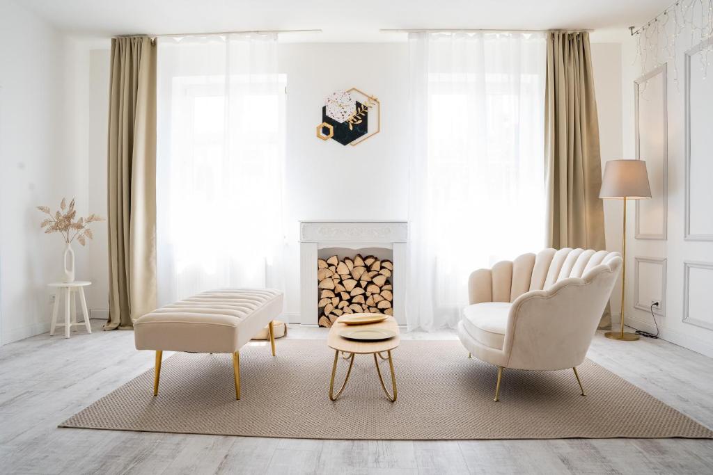 a living room with two chairs and a fireplace at Atelier in Zvěrkovice
