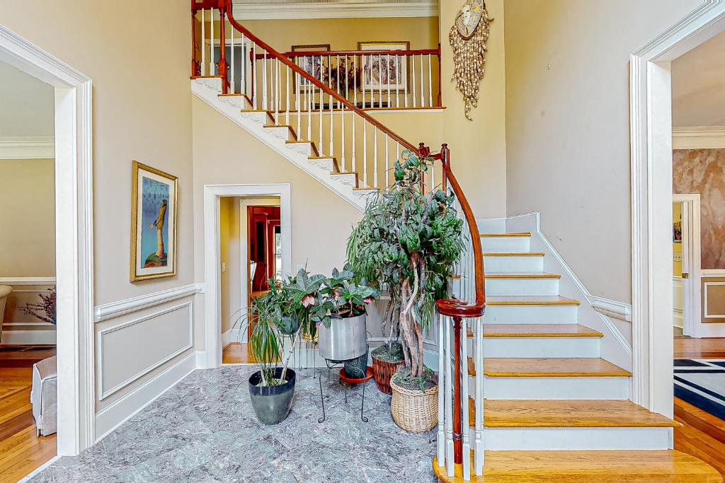 a staircase in a home with potted plants at Fresh Getaway in Fayetteville