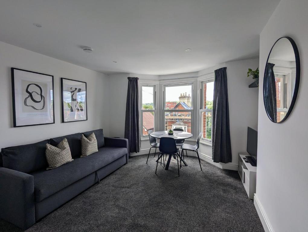 a living room with a couch and a table at Conegra Road by Wycombe Apartments in High Wycombe