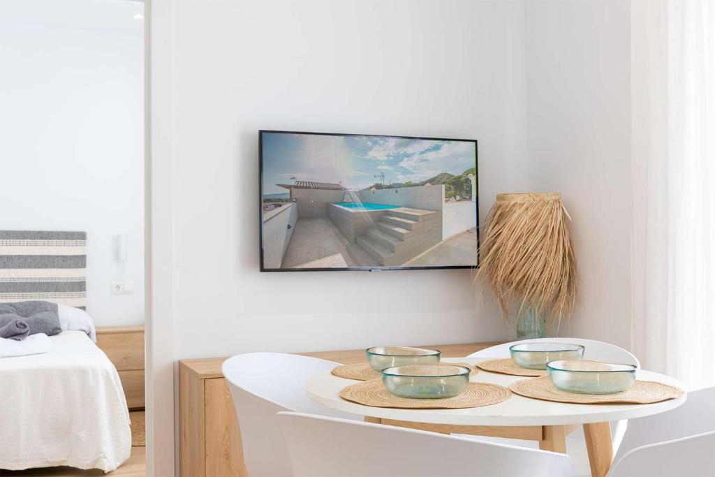 a living room with a table with bowls on it at APARTAMENTOS CARMEN in Maro