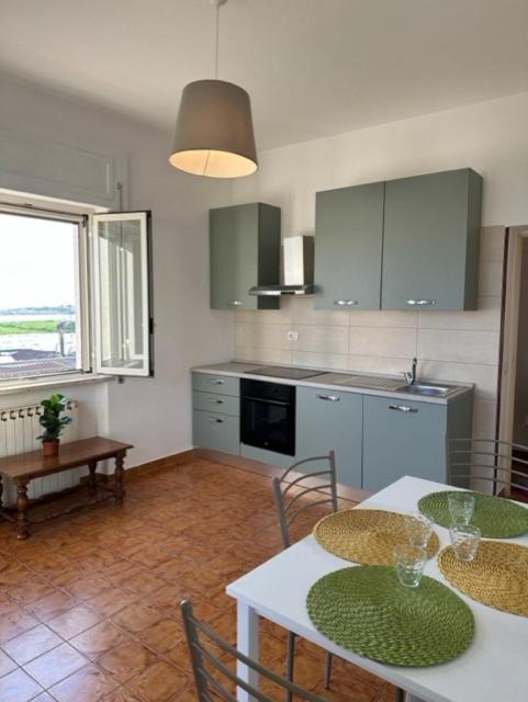 a kitchen with a table and chairs and a kitchen with a window at Casa Lea - Sperlonga in Sperlonga