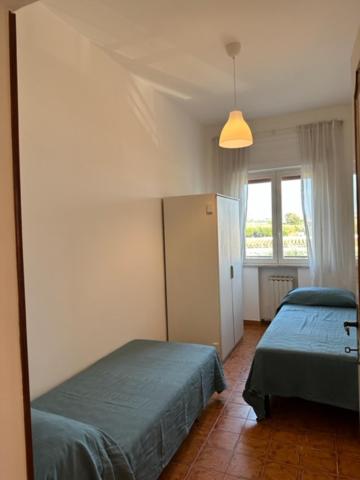 a bedroom with two beds and a window at Casa Lea - Sperlonga in Sperlonga