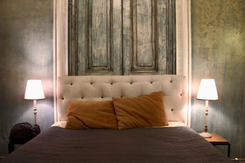 a bedroom with a large bed with two lamps at Angels Roof Vera - boutique apartment. Wine Factory in Tbilisi City