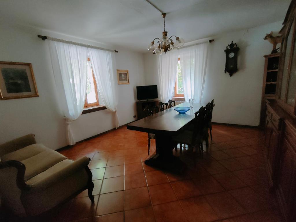 a living room with a table and a couch at Casa Valda in Fanano