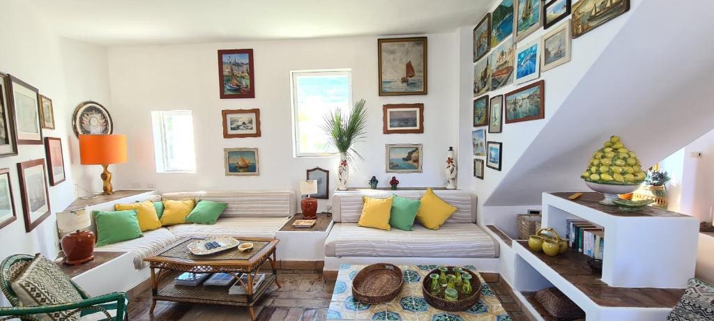 a living room with a white couch and colorful pillows at La Limonaia a mare in Ponza