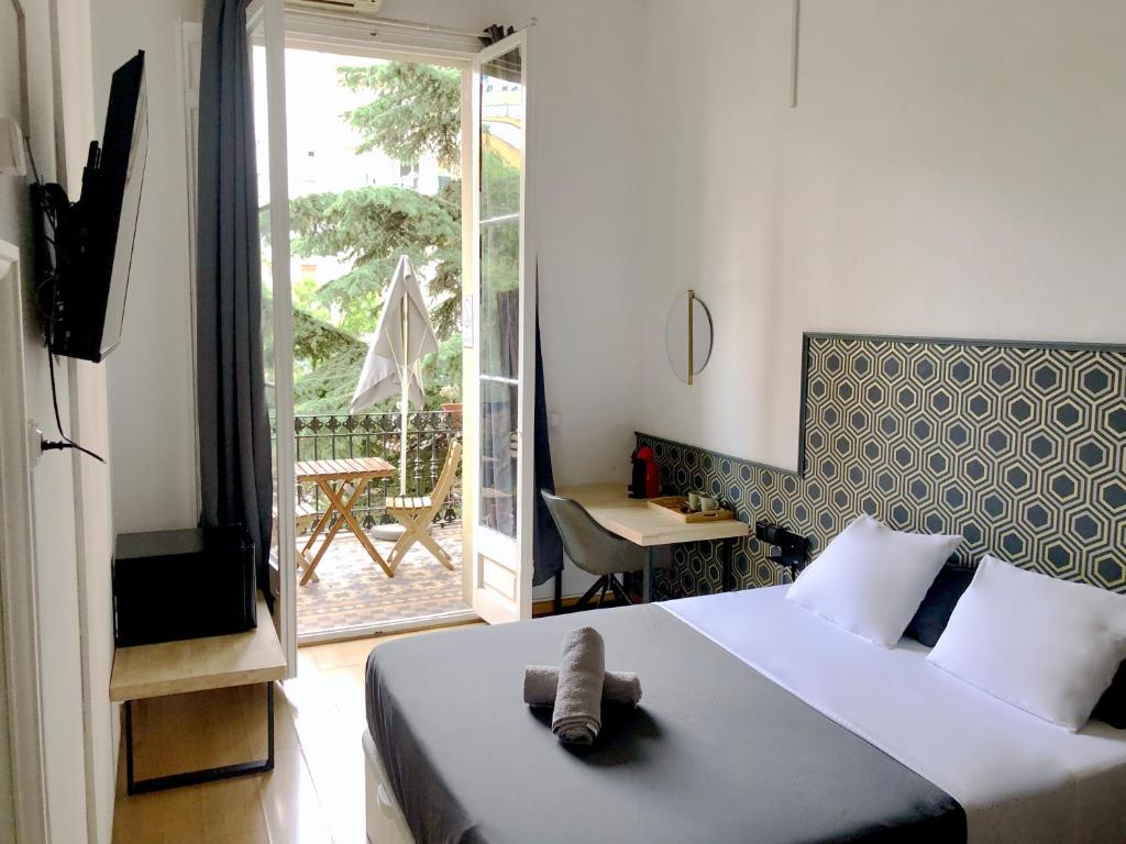 巴塞隆納的住宿－法布里吉奧佩蒂特旅館，一间卧室,床上有泰迪熊