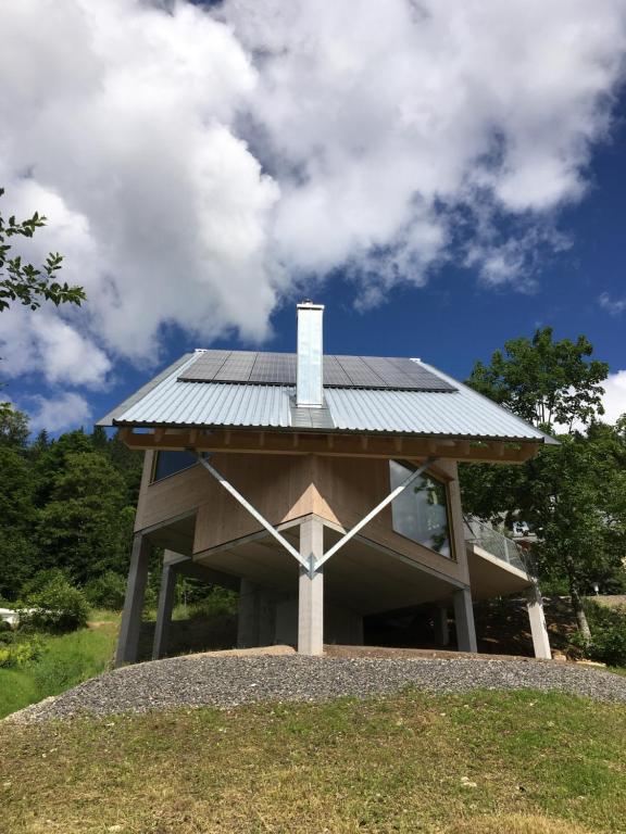 a house with a solar roof on top of a hill at Bleibe Menzenschwand in St. Blasien