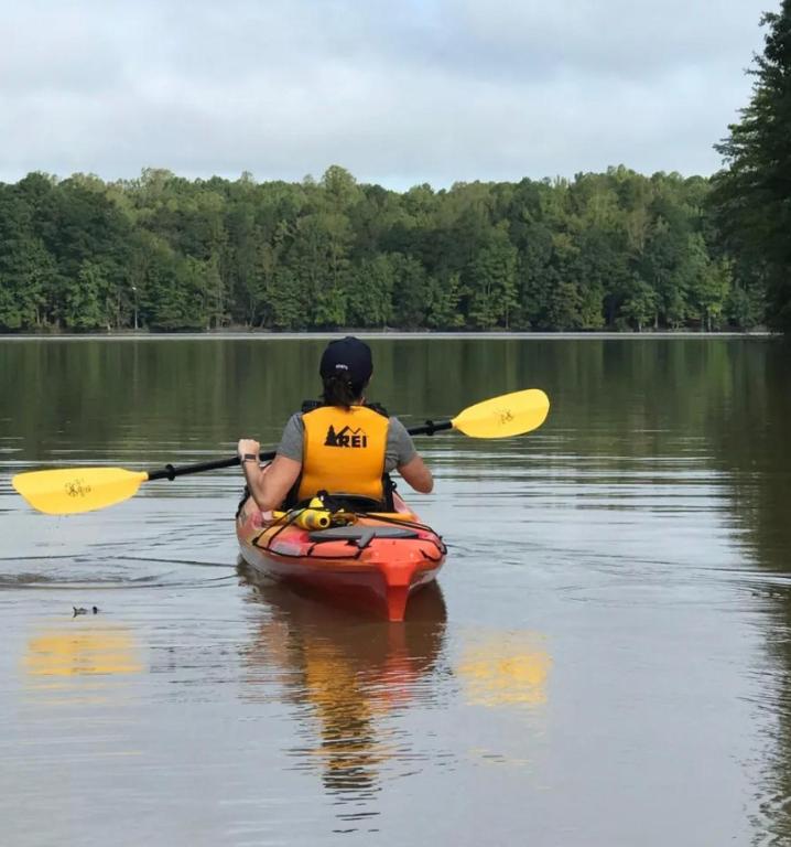 a person in a kayak on a lake at SLEEPS SIX - Rent Entire WATERFRONT CABIN #1 in Etoile