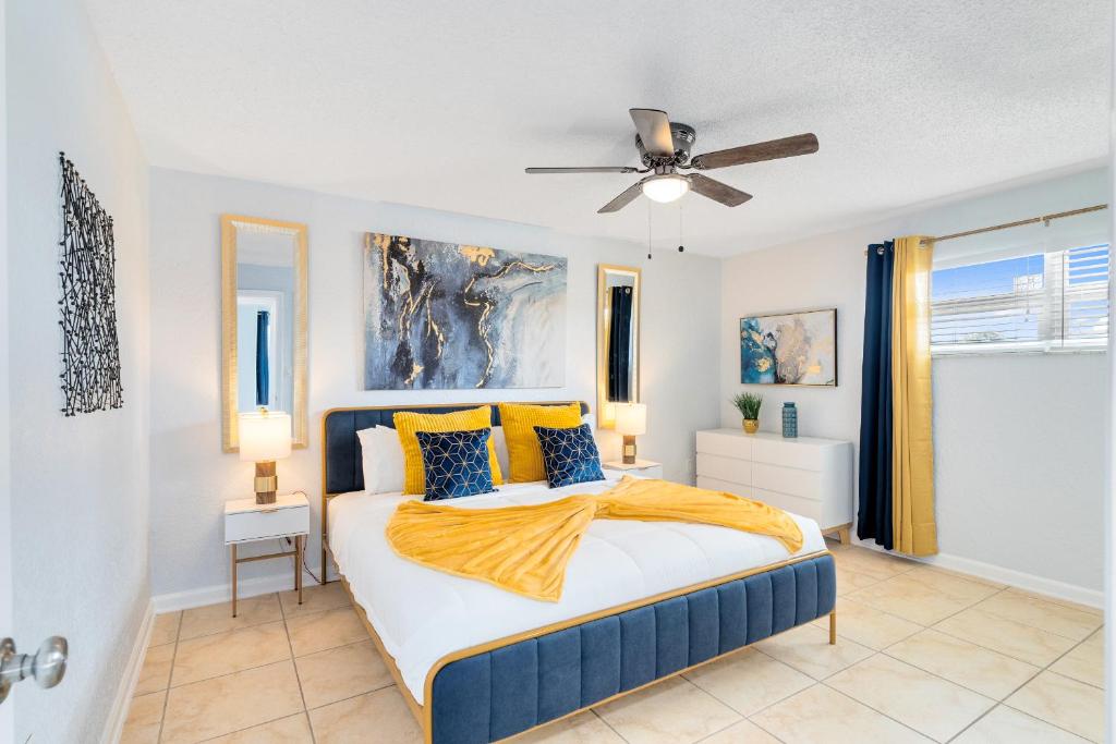 a bedroom with a bed and a ceiling fan at Beachside 32 in Indian Harbour Beach