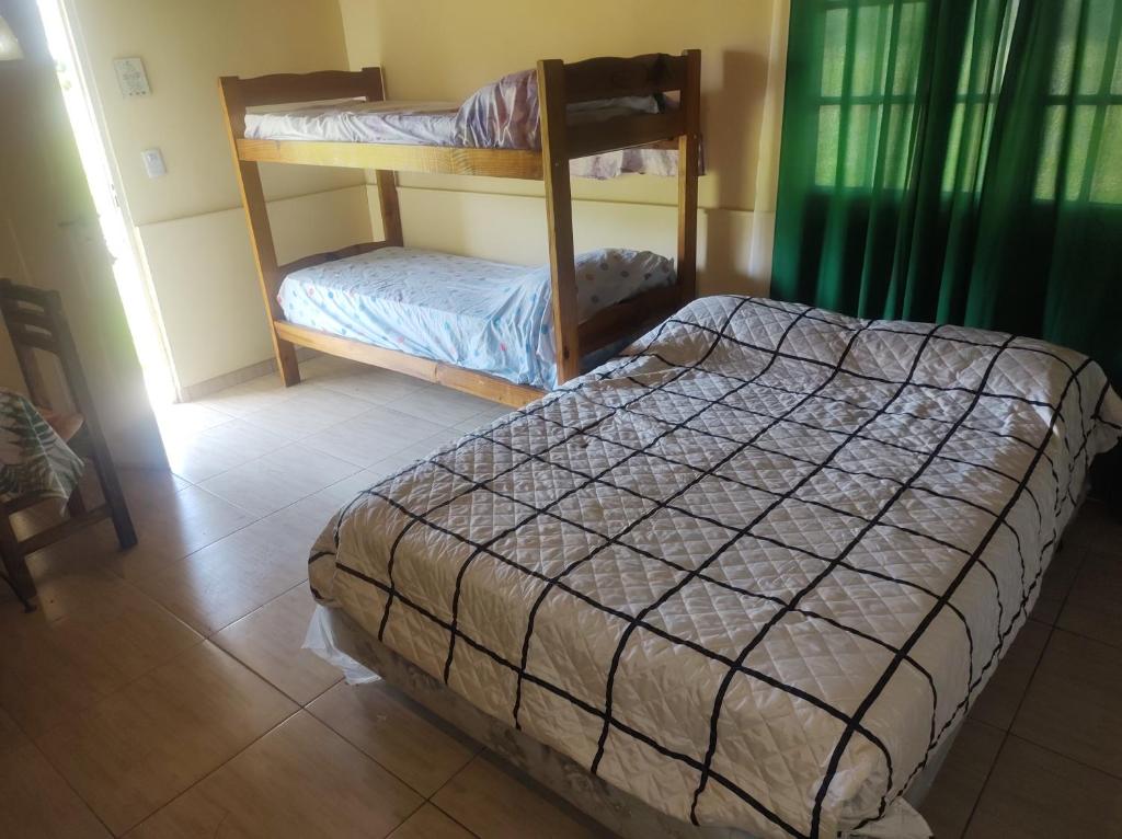 a bedroom with a bed and a bunk bed with aoir at Casa de campo in Colón