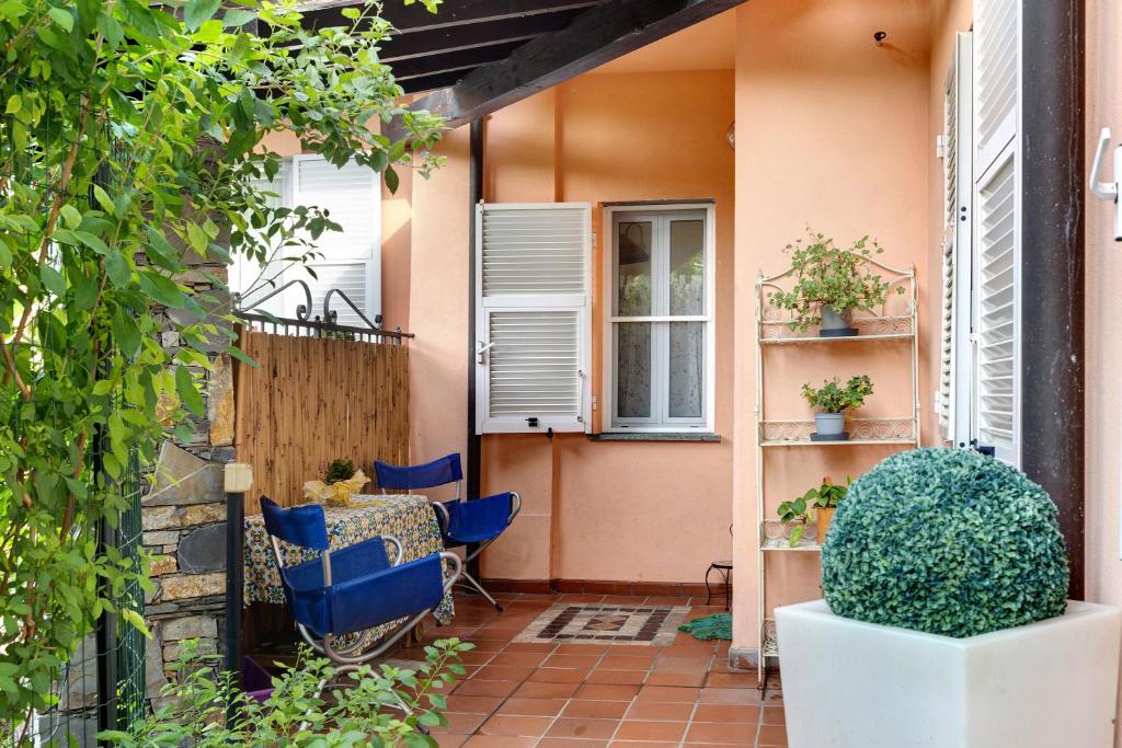 a small patio with blue chairs and a table at Home Charlene in Albenga