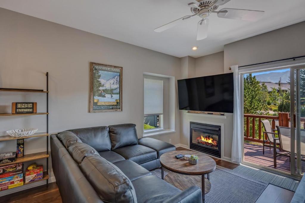 a living room with a couch and a fireplace at 1032 Luxury Eaglepointe Townhome in Steamboat Springs