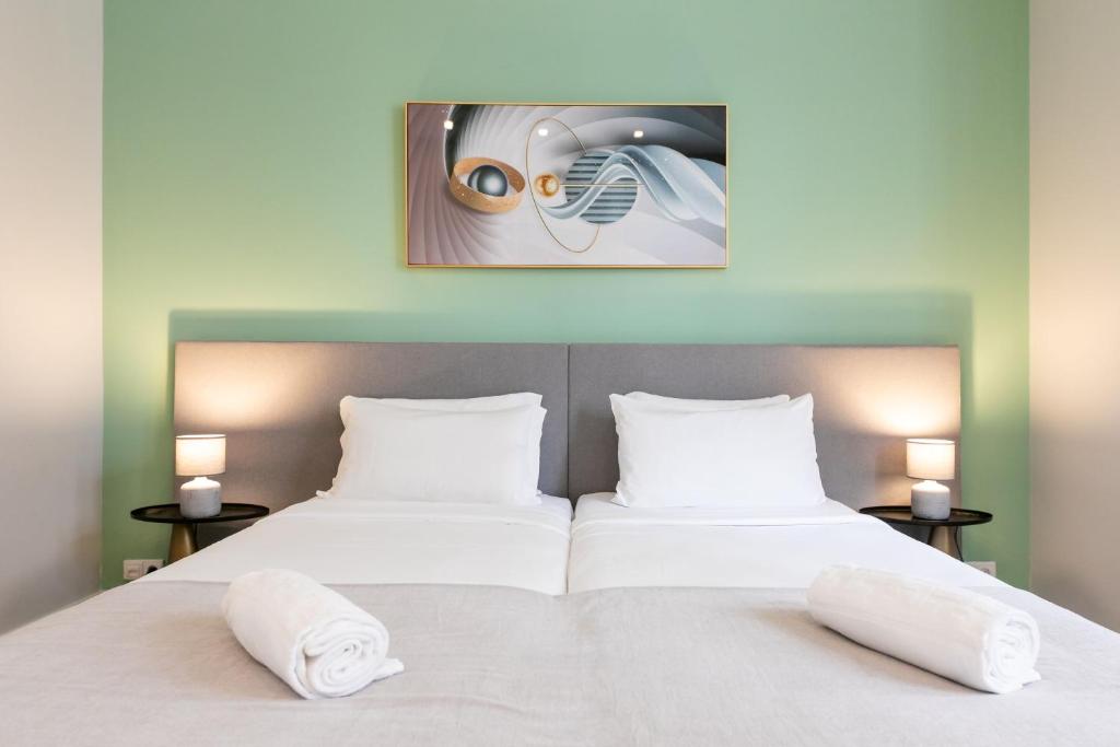 two beds in a room with two white pillows at Lisboa 85 Suites & Apartments by RIDAN Hotels in Lisbon