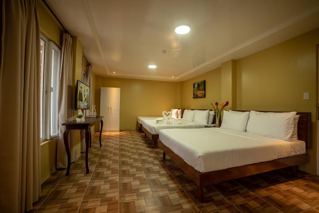 Postel nebo postele na pokoji v ubytování Bernardo's Lantia Hotel