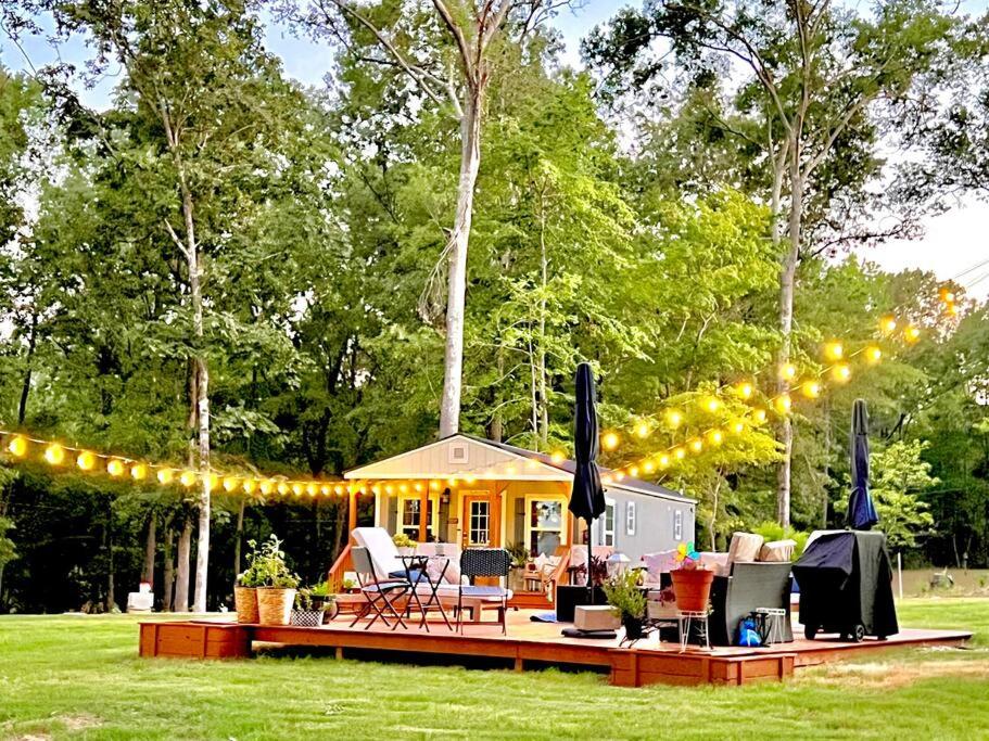 a backyard party with a string of lights at SLEEPS SIX - Rent Entire WATERFRONT Cabin #2 in Etoile