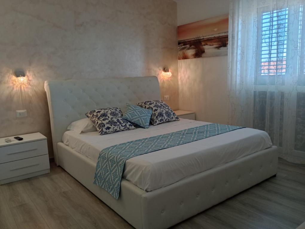 a bedroom with a large bed with pillows on it at Viola di Mare Rooms and Parking in Termoli
