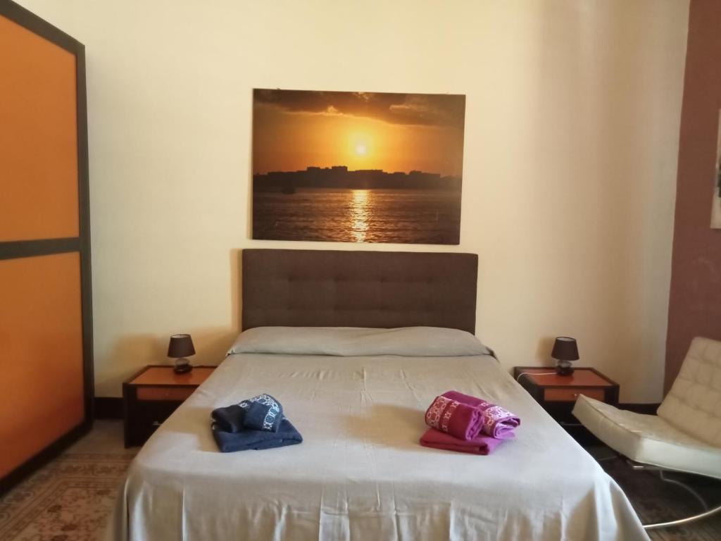 two towels on a bed in a room at Kalsa Apartment in Palermo