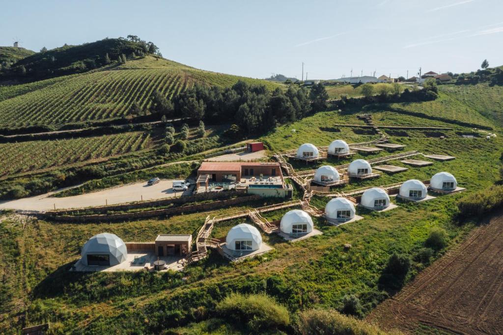 an aerial view of a farm with domes on a hill at Sóis Montejunto Eco Lodge in Alenquer