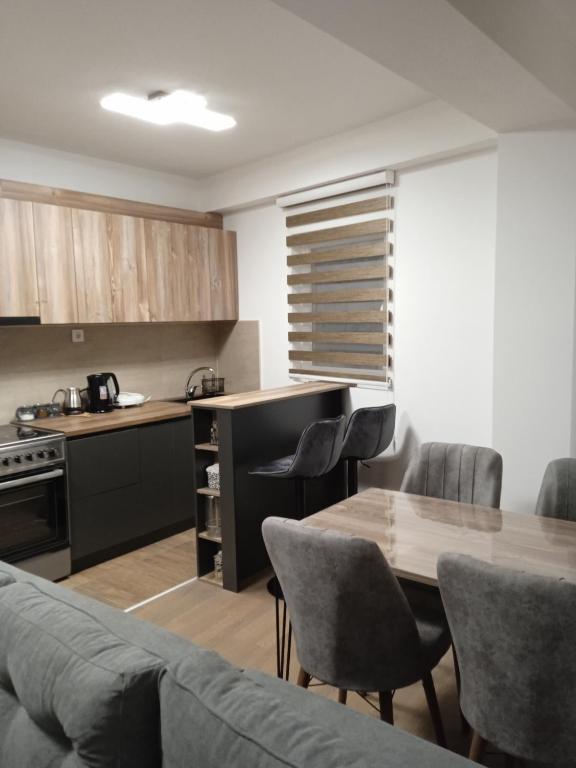 a kitchen and dining room with a table and chairs at Eva apartment in Štip