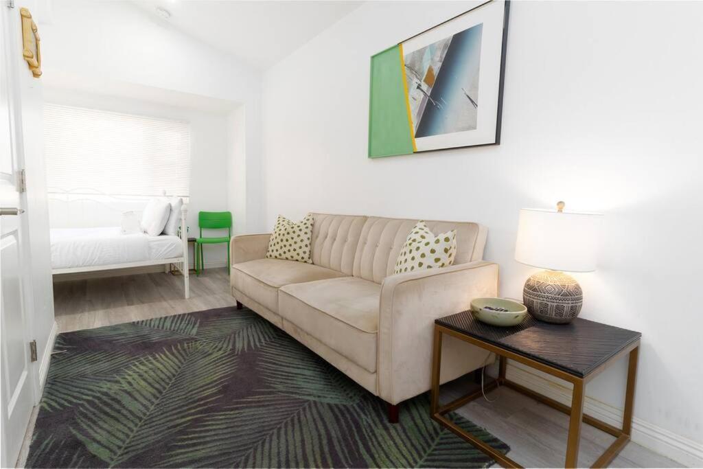 a living room with a couch and a table at Studio Bungalow in the Heart of Normal Heights in San Diego