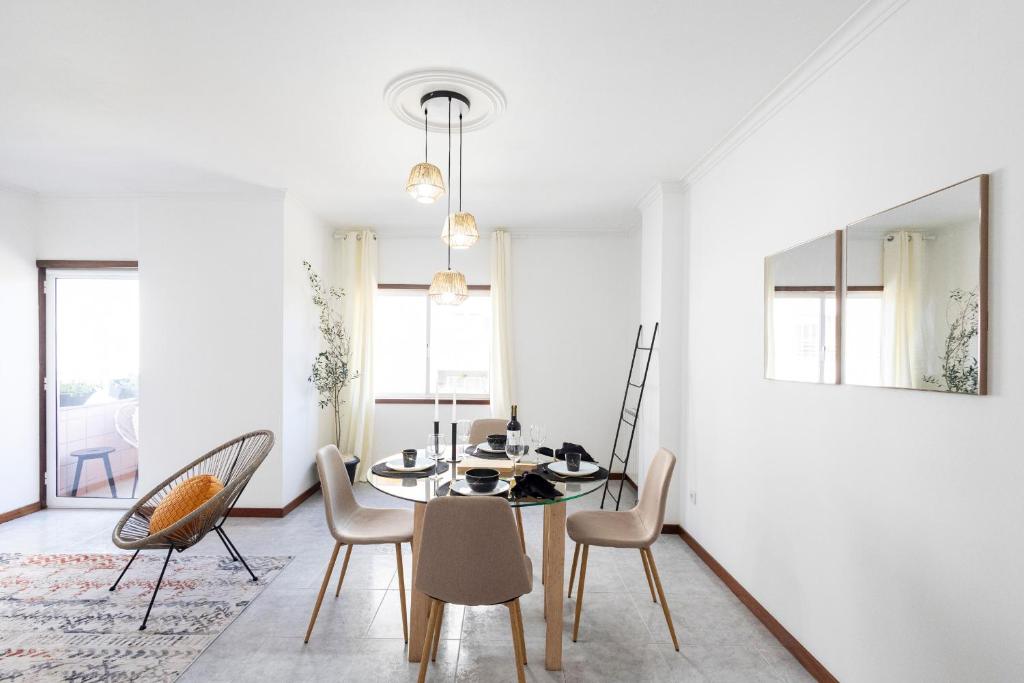 a dining room with a table and chairs at Braga 3BR Wonder by LovelyStay in Braga