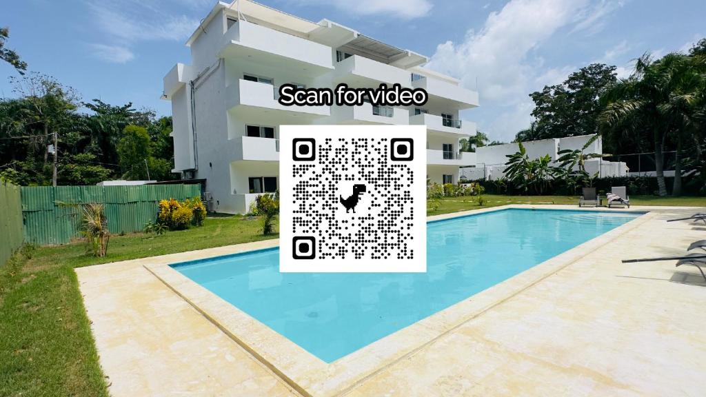 una villa con piscina di fronte a un edificio di Estrella Residences - Two Bedroom a Cabarete