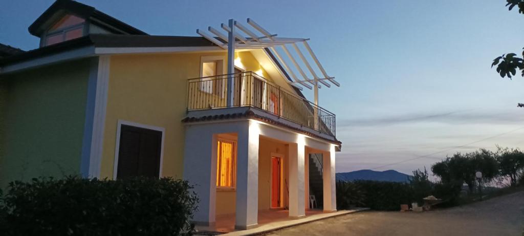 a house with a balcony and a windmill on it at Villa Lancellotti in Agropoli