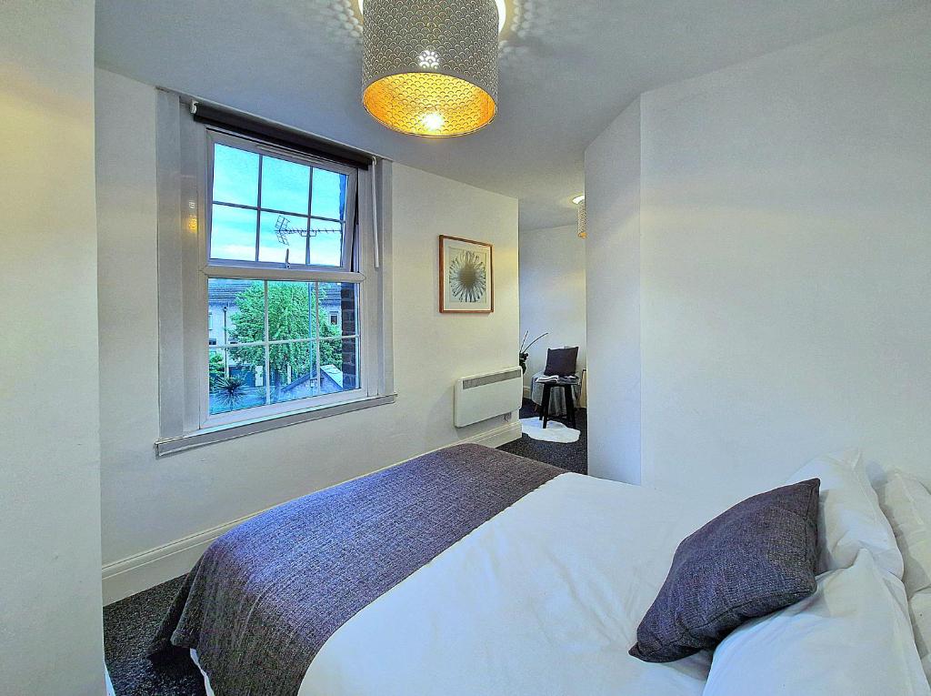 a bedroom with a white bed and a window at Charming room in Central London in London