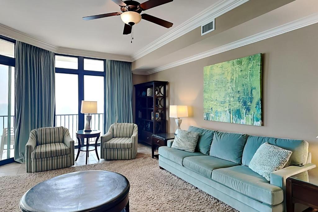 a living room with a couch and a table at Phoenix West II #1407 in Orange Beach