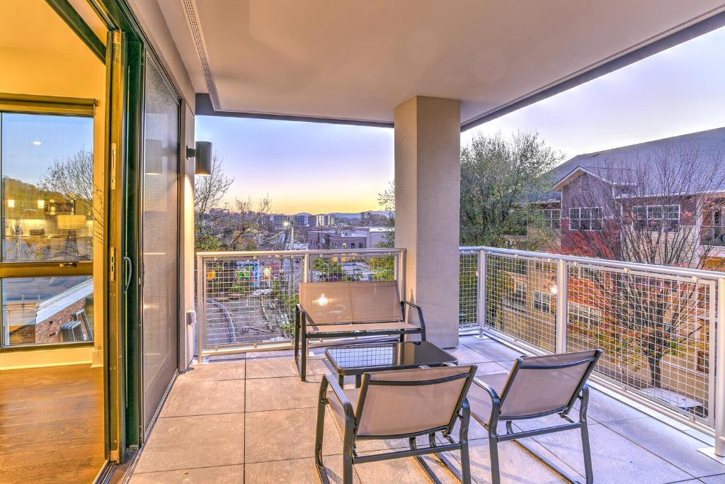 a balcony with chairs and a table with a laptop on it at 145 Biltmore Ave Condo 541B0A in Asheville