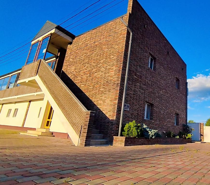 a brick building with a staircase on the side of it at Fresh Accommodation in Rădăuţi