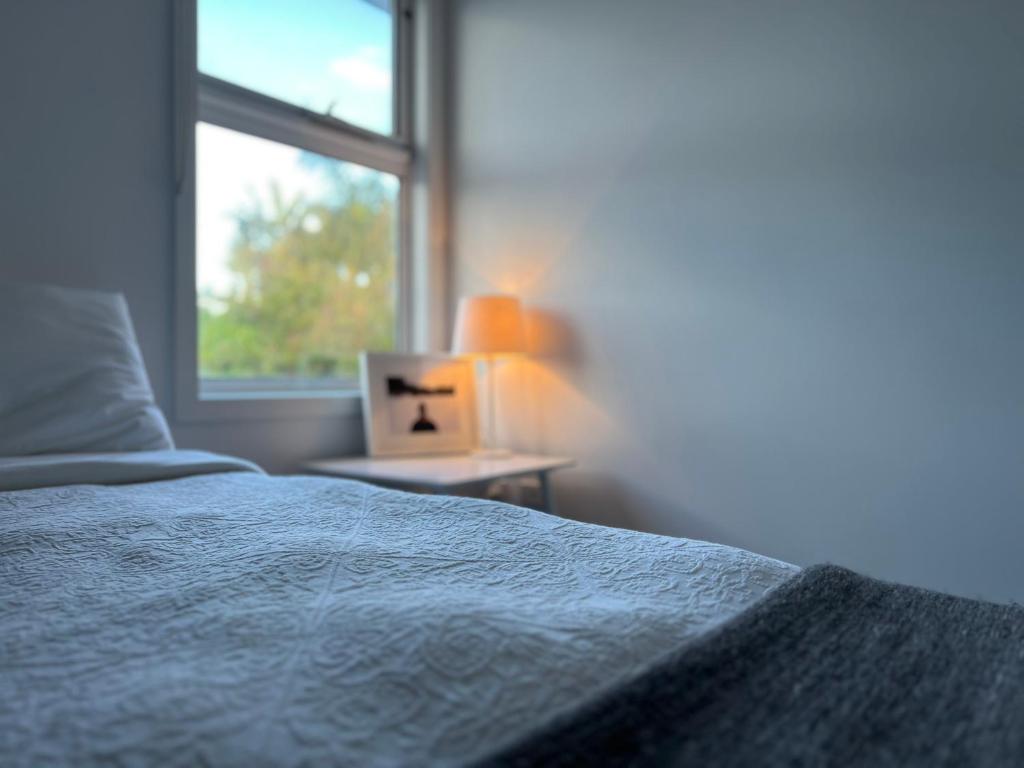 a bedroom with a bed next to a window at Rosebud Lovely House 2 - Mornington Peninsula 4 BR 3 Bath 2 story holiday house - BBQ - Beach - Hot spring in Rosebud