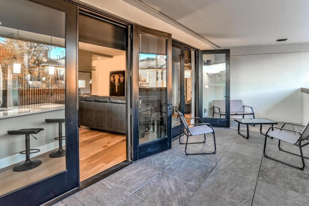 a lobby with glass doors and chairs and a couch at 145 Biltmore Avenue Condo 541B0E in Asheville