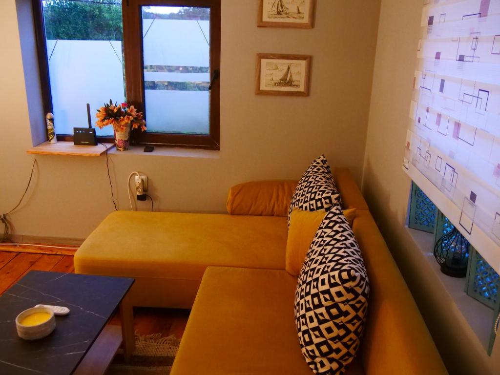 a living room with a couch and a table at Cactus house in Ovchartsi