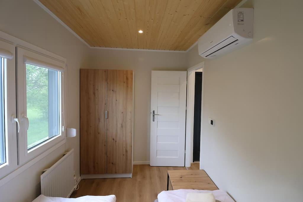a room with two beds and a door at Mobilheim 