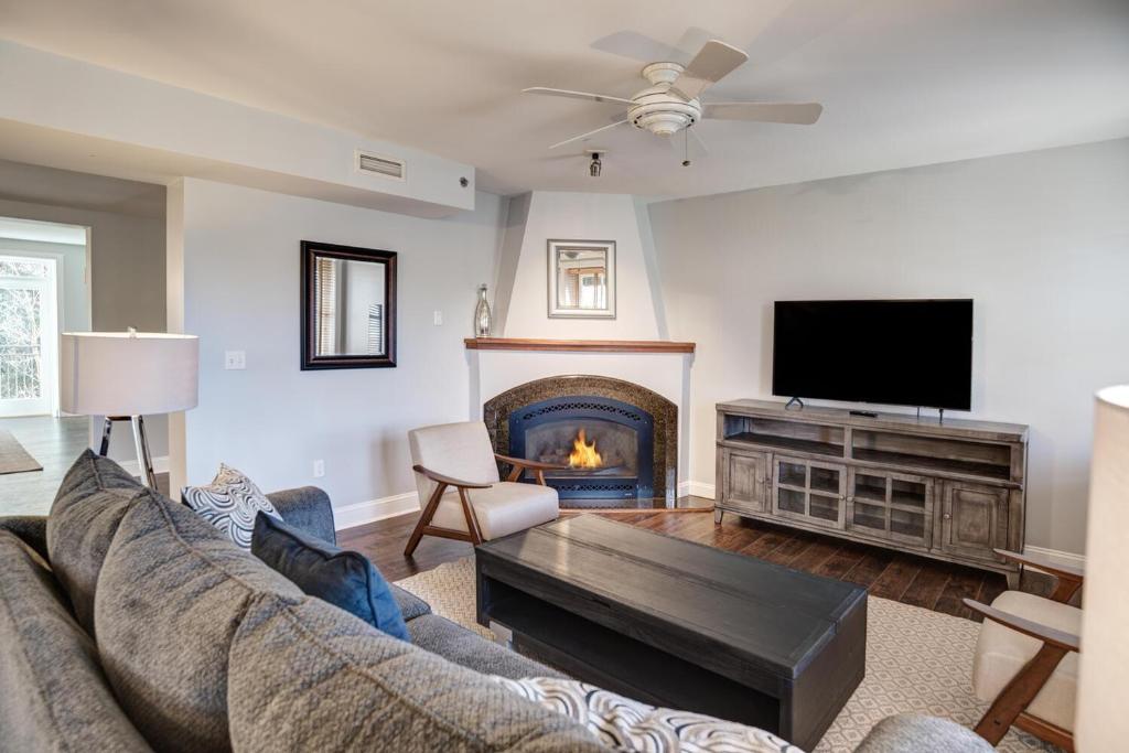 a living room with a couch and a fireplace at 8 Village Lane 200 in Asheville