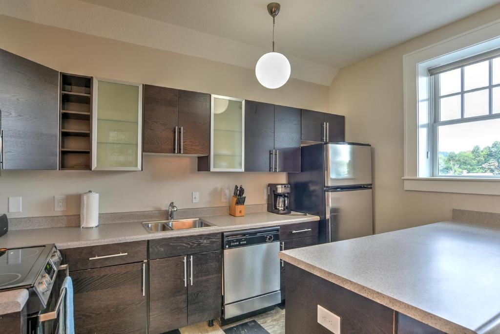 a kitchen with wooden cabinets and stainless steel appliances at Historic King James Unit 1 in Asheville