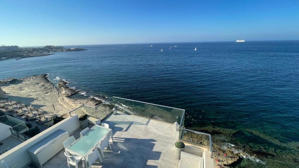 a view of the ocean from the balcony of a house at Stunning penthouse, 2 bedroom, heart of Sliema in Sliema