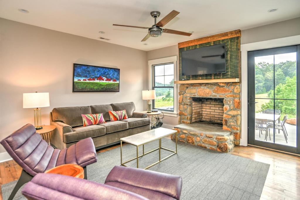 a living room with a couch and a fireplace at Dogwood Farmhouse in Candler